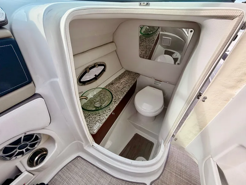 Slide: The Image of Interior of 2023 Crownline 285 XS with toilet and sink. - 8