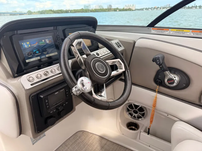 Slide: The Image of 2023 Crownline 285 XS helm with Garmin display and controls. - 9