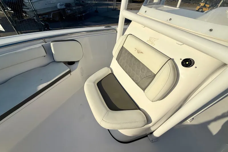 Slide: The Image of 2020 Tidewater 210 LXF boat interior with cushioned seating and console details. - 7