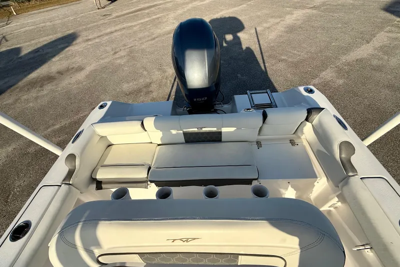 Slide: The Image of 2020 Tidewater 210 LXF boat interior with seating and outboard motor. - 9