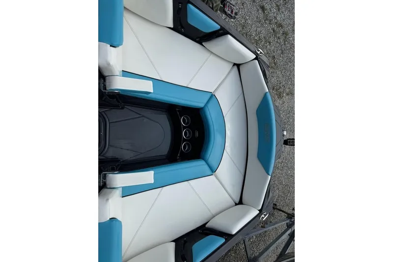 Slide: The Image of 2021 Heyday WTSurf boat interior with blue and white seating, cup holders visible. - 3