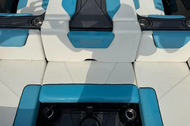 Slide: The Image of 2021 Heyday WTSurf boat interior with blue and white seating and cup holders. - 4