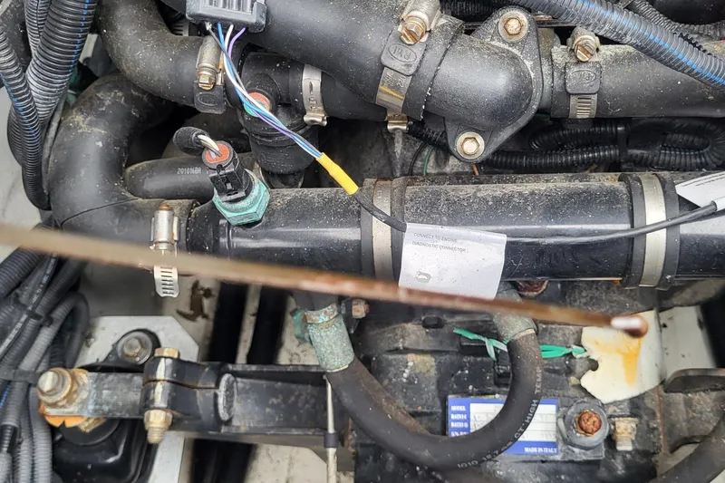 Slide: The Image of Engine components of a 2021 Heyday WTSurf boat, featuring hoses and wiring. - 13