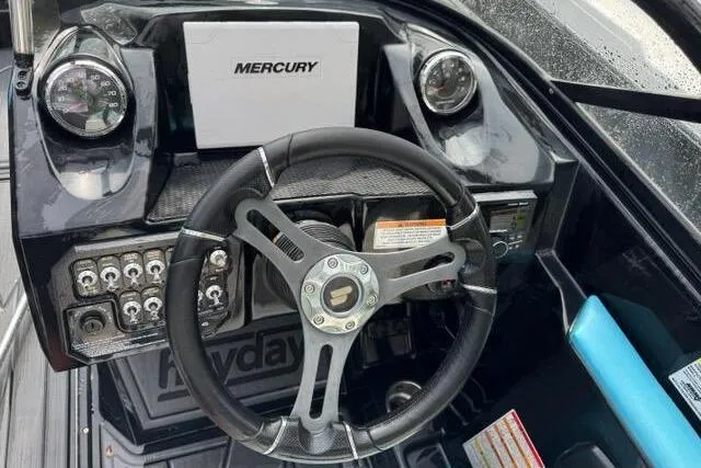 Slide: The Image of Steering wheel and dashboard of 2021 Heyday WTSurf boat with Mercury controls. - 7