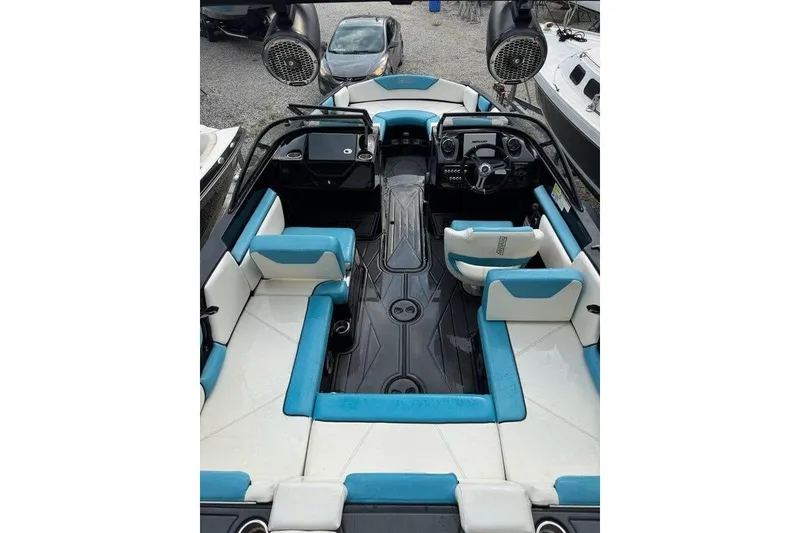 Slide: The Image of 2021 Heyday WTSurf boat interior with blue and white seating, modern dashboard, and speakers. - 8