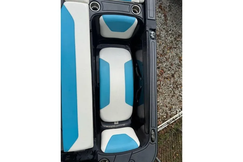 Slide: The Image of 2021 Heyday WTSurf boat interior with blue and white seating, cup holders visible. - 9