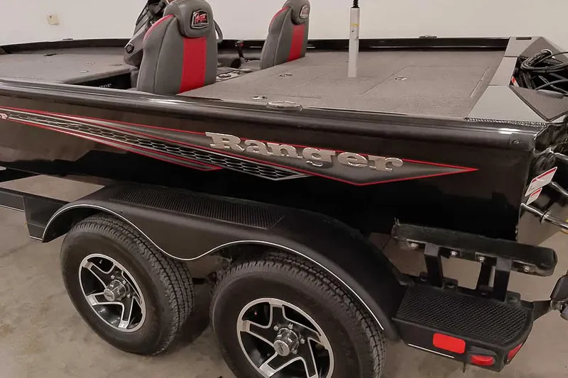 Slide: The Image of 2023 Ranger RT198P boat with dual seats and sleek black design. - 12