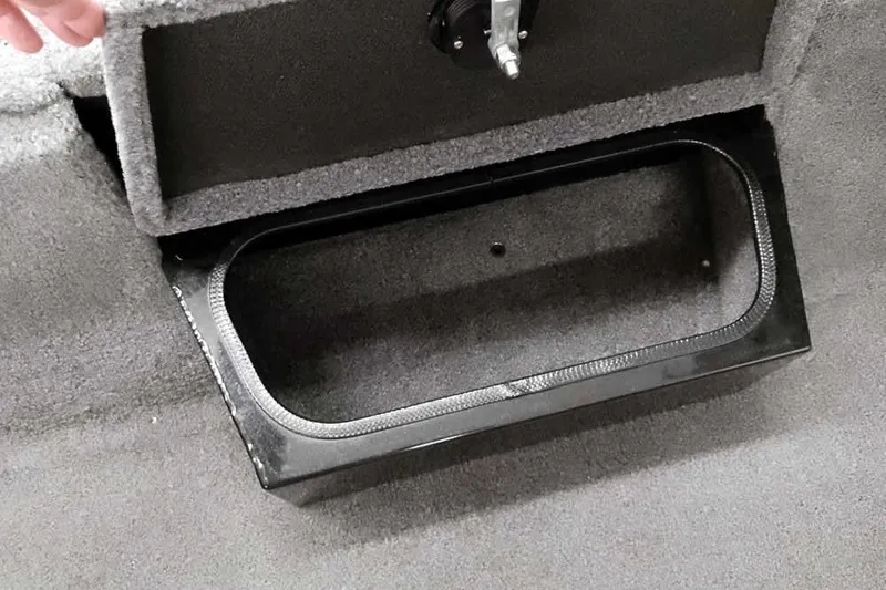 Slide: The Image of 2023 Ranger RT198P boat storage compartment with carpeted interior and black trim. - 18