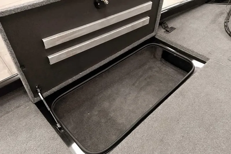 Slide: The Image of 2023 Ranger RT198P boat storage compartment with open lid, showcasing spacious interior. - 22