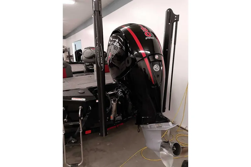 Slide: The Image of 2023 Ranger RT198P boat with powerful outboard motor in a garage setting. - 3