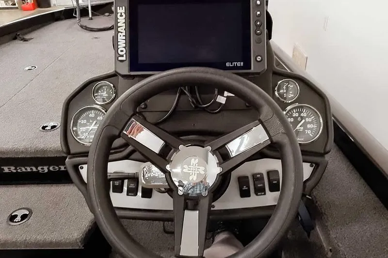 Slide: The Image of 2023 Ranger RT198P boat dashboard with steering wheel and Lowrance Elite display. - 34