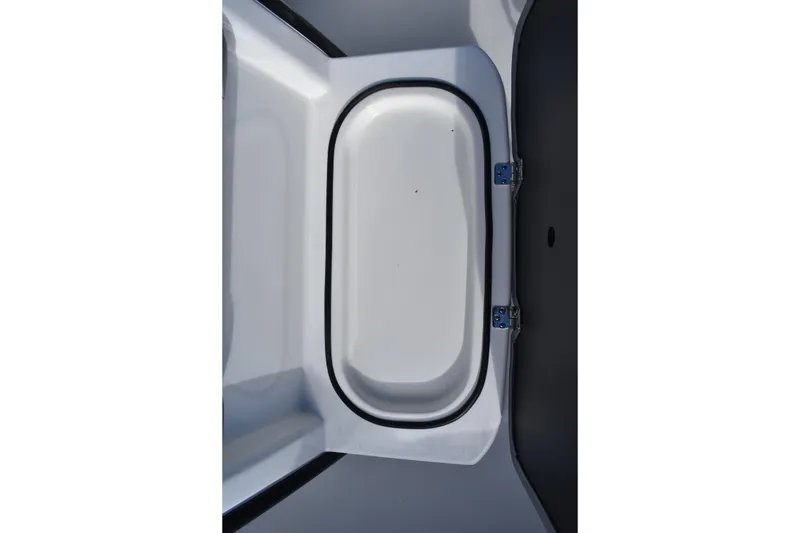 Slide: The Image of 2022 NauticStar 2602 Legacy boat on trailer, parked in marina with covered boats. - 10