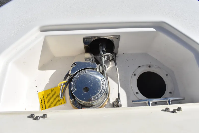 Slide: The Image of 2022 NauticStar 2602 Legacy boat storage compartment with secure hinges. - 16