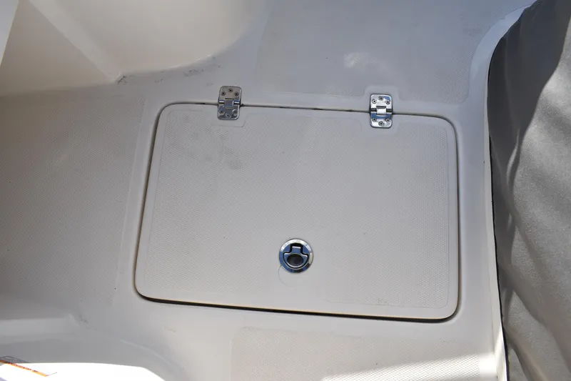 Slide: The Image of 2022 NauticStar 2602 Legacy boat interior with cushioned seating and cup holders. - 17