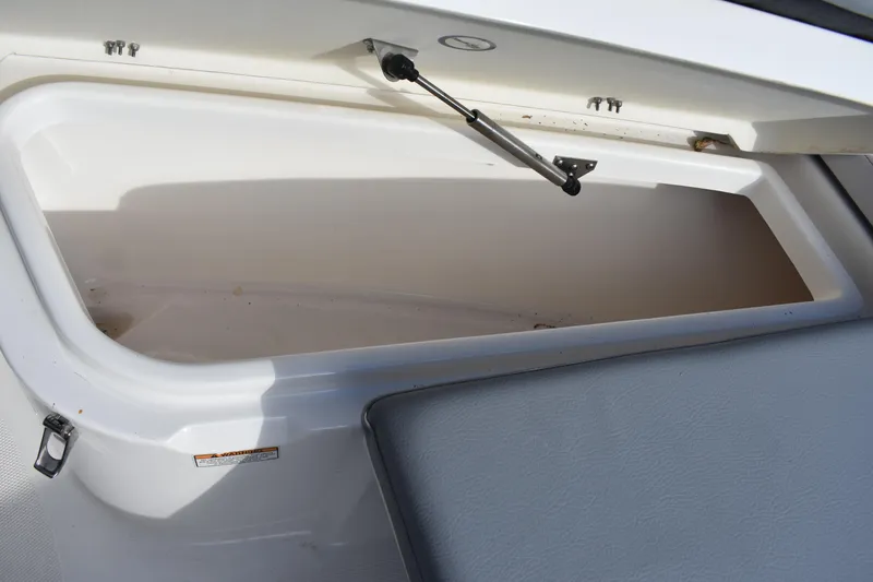 Slide: The Image of Anchor compartment of 2022 NauticStar 2602 Legacy boat with winch and chain. - 22