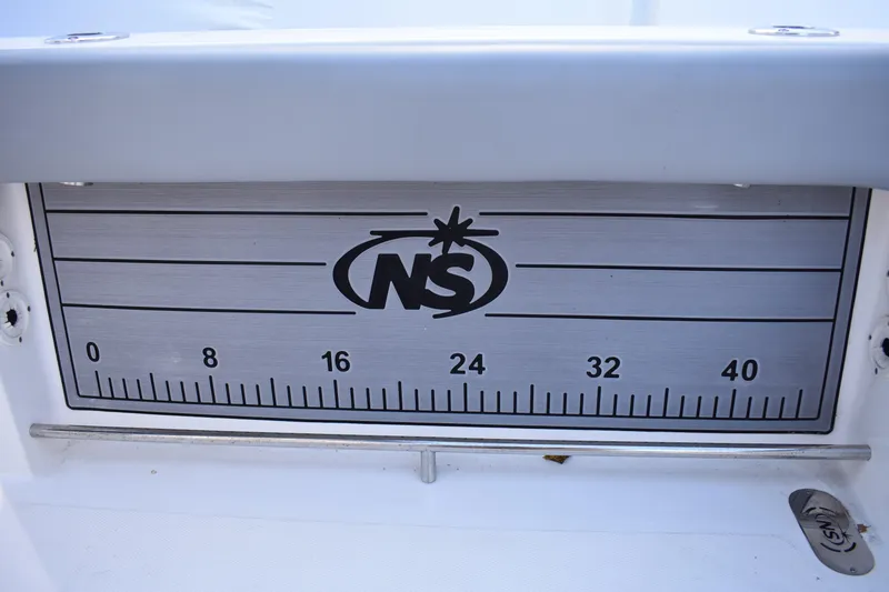 Slide: The Image of 2022 NauticStar 2602 Legacy boat seating area with gray and white cushions. - 29