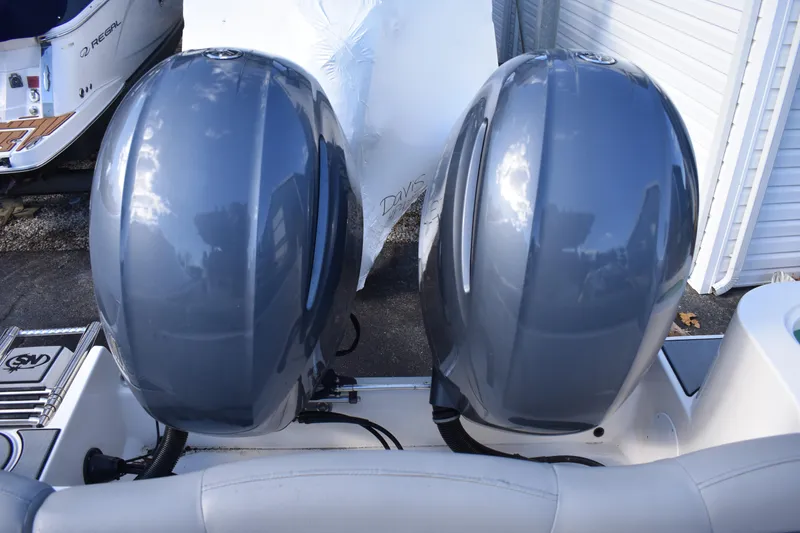 Slide: The Image of 2022 NauticStar 2602 Legacy boat seating with gray and white cushioned design. - 32