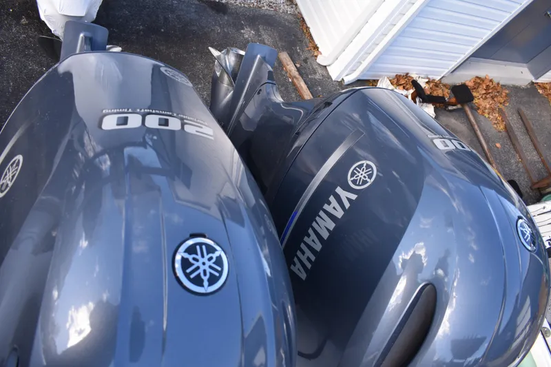 Slide: The Image of 2022 NauticStar 2602 Legacy boat seating with gray upholstery and armrests. - 33