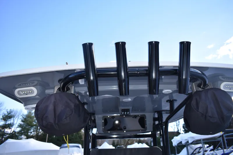 Slide: The Image of 2022 NauticStar 2602 Legacy boat deck with ladder and logo detail. - 36