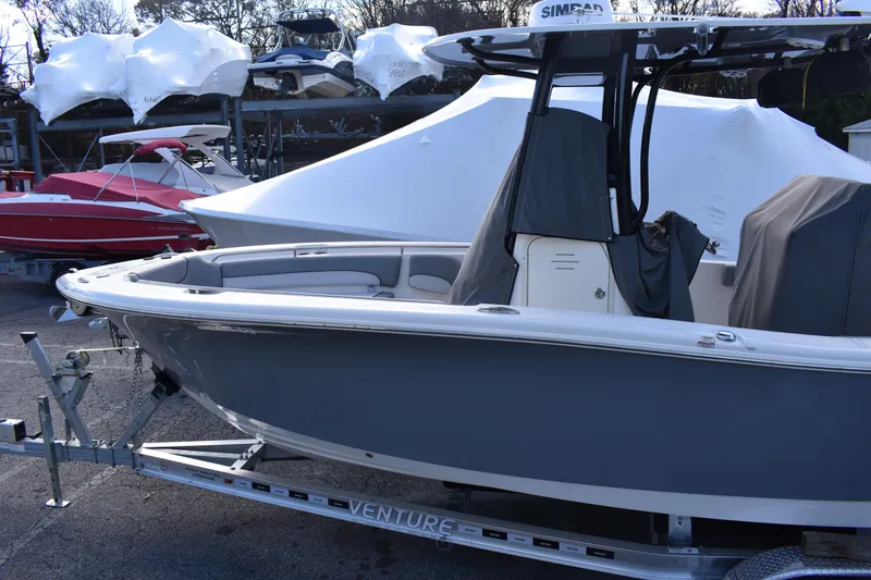 Slide: The Image of 2022 NauticStar 2602 Legacy boat on trailer outside marine dealership. - 4