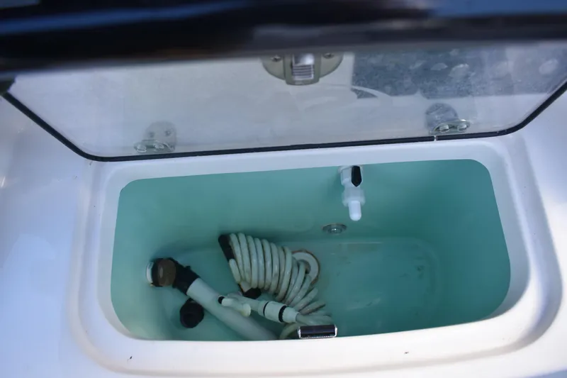 Slide: The Image of Storage compartment with coiled hose on 2022 NauticStar 2602 Legacy boat. - 41