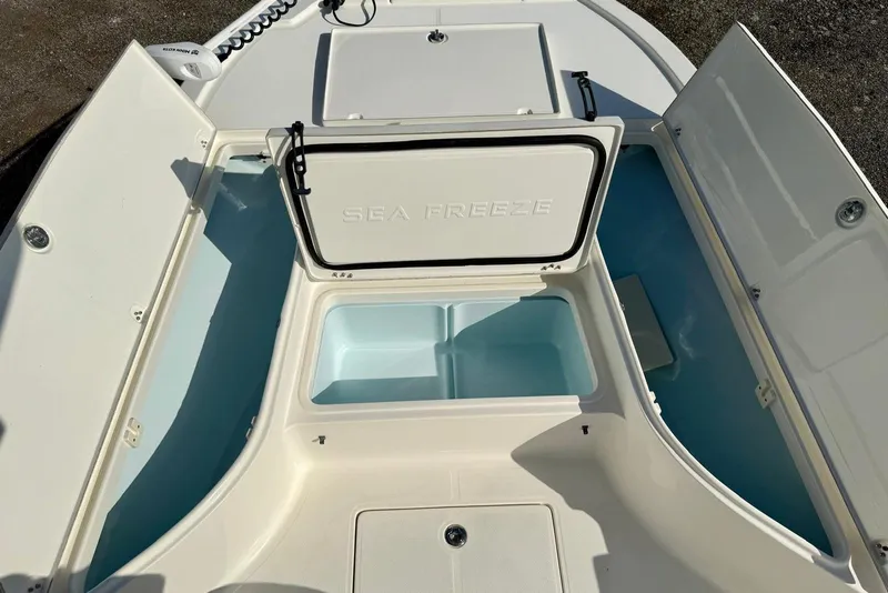 Slide: The Image of 2017 Sea Born FX24 Bay boat storage compartments open, showcasing spacious interior. - 13