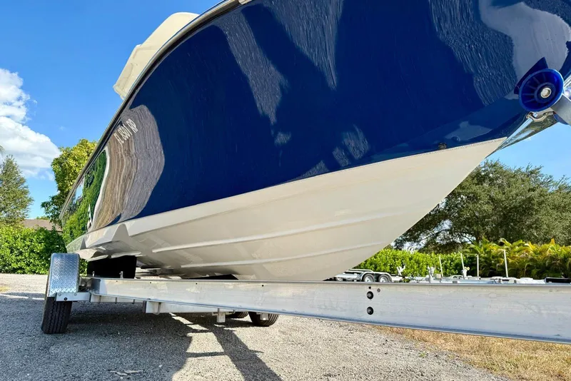 Slide: The Image of 2017 Sea Born FX24 Bay boat on trailer under clear blue sky. - 7