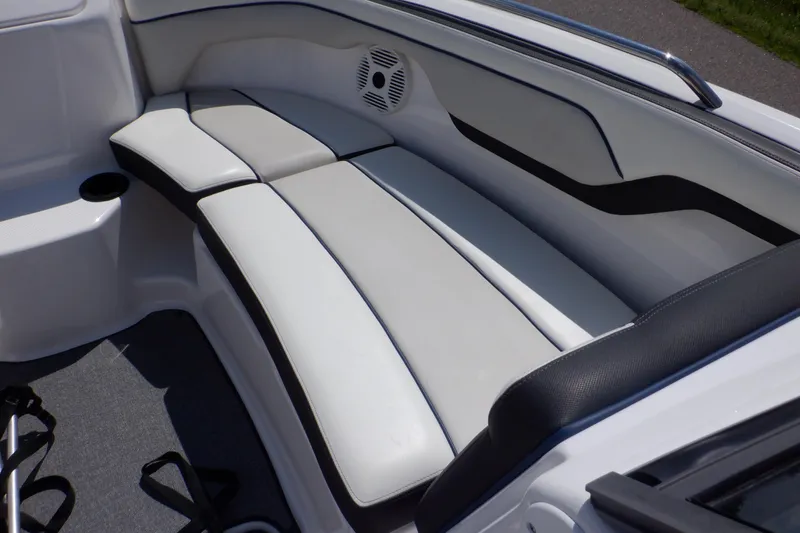 Slide: The Image of 2019 Yamaha SX210 boat interior with white cushioned seating and speaker. - 10