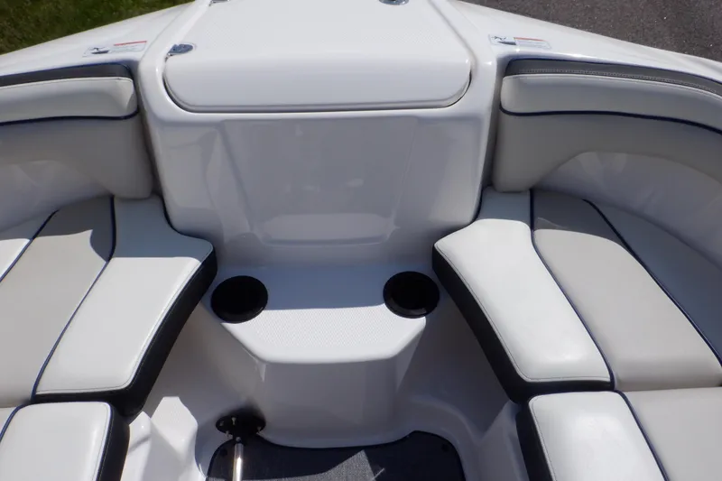Slide: The Image of 2019 Yamaha SX210 boat interior with cushioned seating and cup holders. - 12