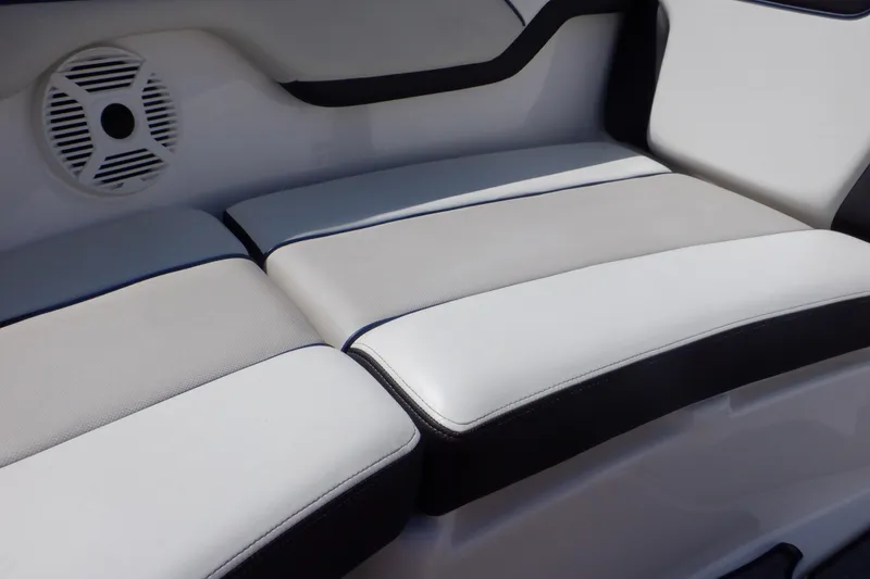 Slide: The Image of 2019 Yamaha Boats SX210 interior seating with speaker, featuring sleek white and black design. - 15