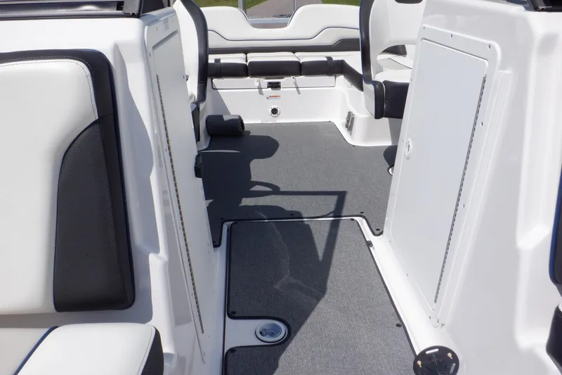 Slide: The Image of 2019 Yamaha SX210 boat interior with white and black seating and gray flooring. - 17