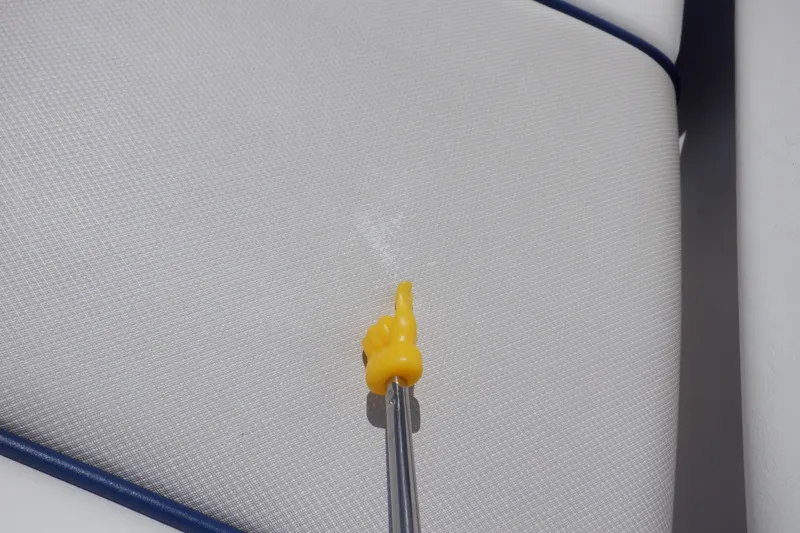 Slide: The Image of Yellow pointer indicating a spot on 2019 Yamaha SX210 boat upholstery. - 18