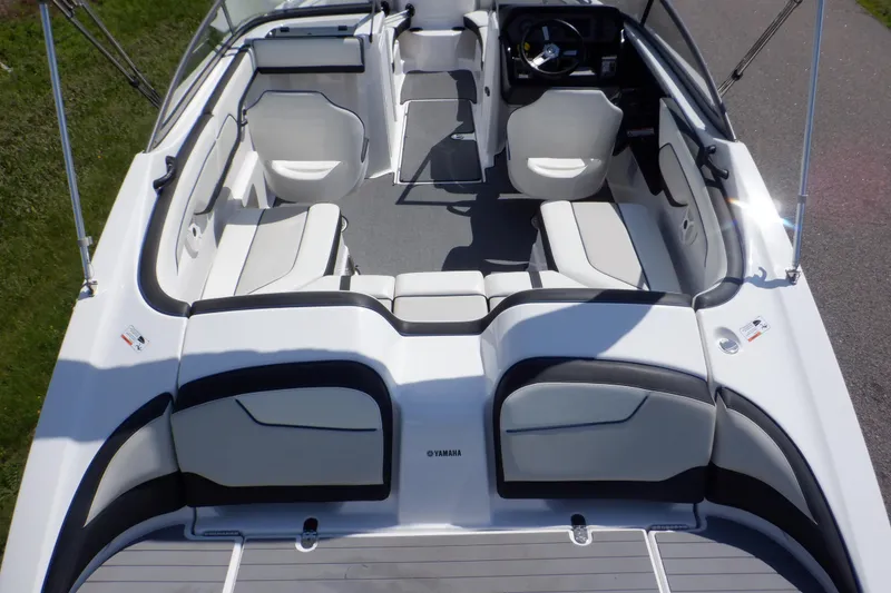 Slide: The Image of 2019 Yamaha Boats SX210 interior with sleek seating and modern dashboard design. - 2