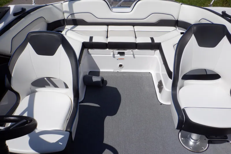 Slide: The Image of 2019 Yamaha Boats SX210 interior with white and black seating, showcasing modern design. - 21