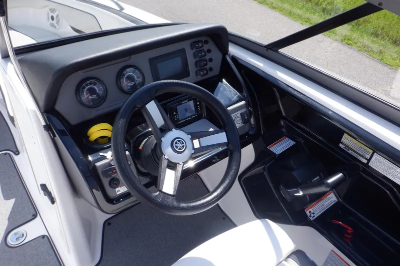 Slide: The Image of 2019 Yamaha SX210 boat dashboard with steering wheel and control panel. - 25