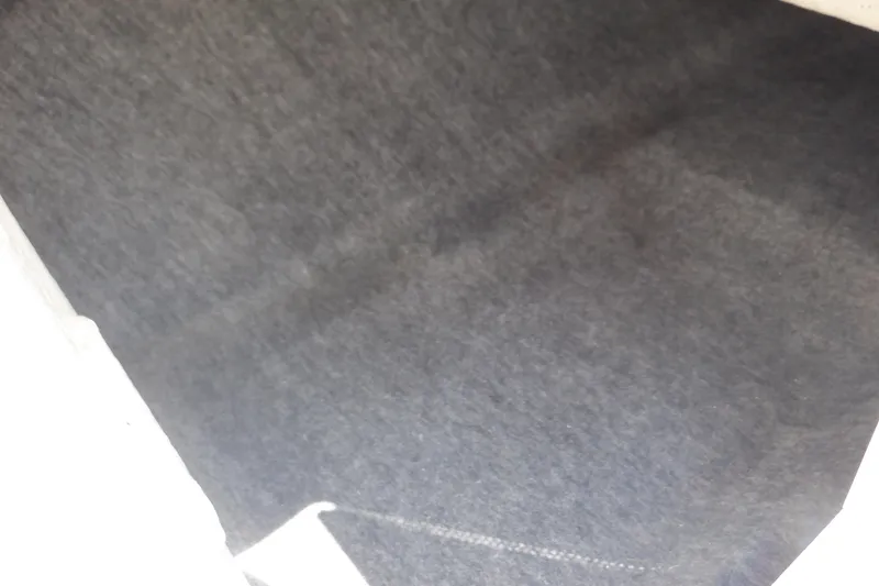 Slide: The Image of Interior view of a 2019 Yamaha SX210 boat, featuring dark upholstery. - 27