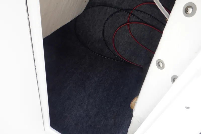 Slide: The Image of 2019 Yamaha SX210 boat storage compartment with visible wiring. - 28