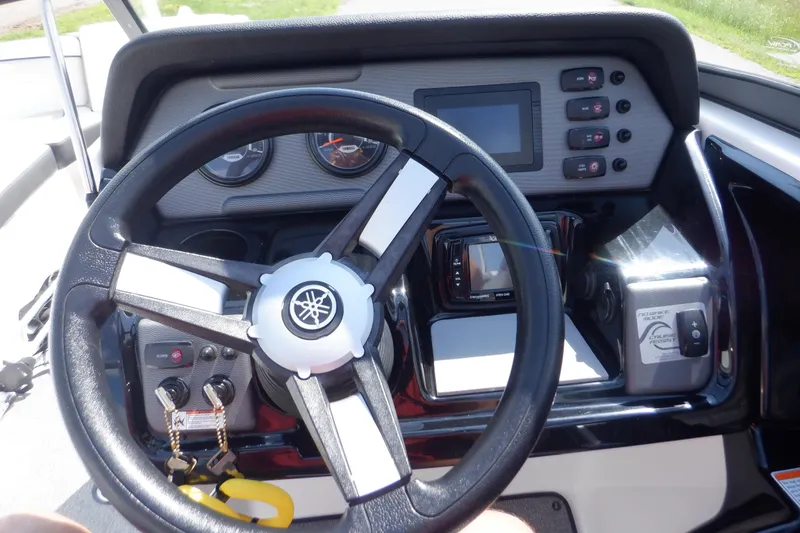 Slide: The Image of 2019 Yamaha Boats SX210 dashboard with steering wheel and control panel. - 36