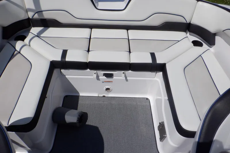 Slide: The Image of 2019 Yamaha Boats SX210 interior seating with white and black upholstery. - 39