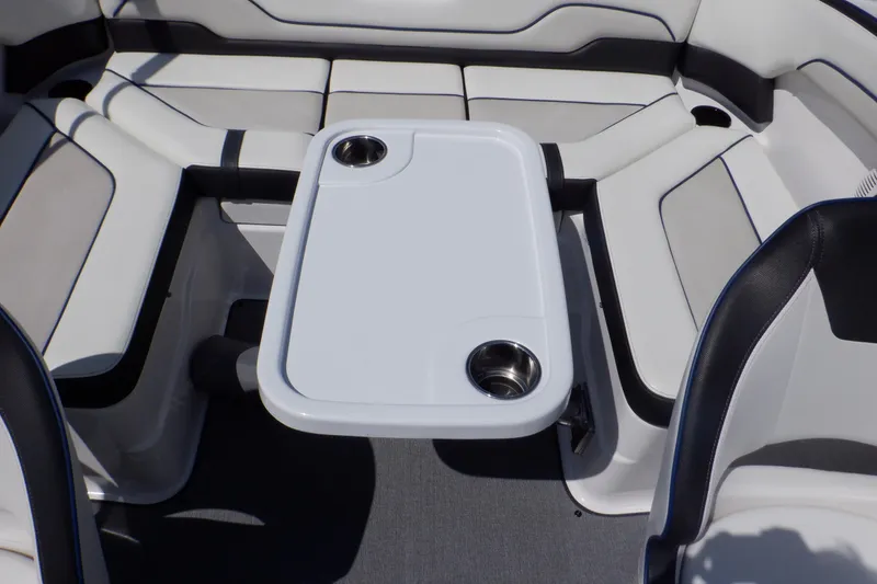 Slide: The Image of 2019 Yamaha Boats SX210 interior with seating and table featuring cup holders. - 45