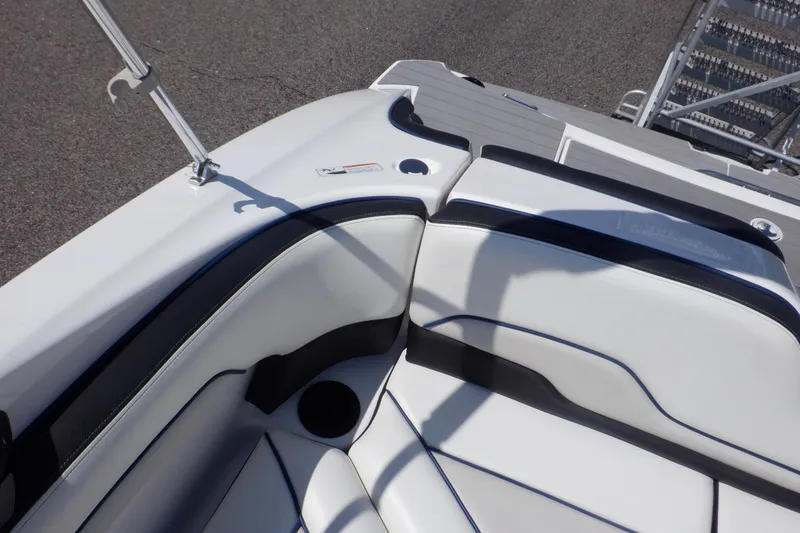 Slide: The Image of 2019 Yamaha Boats SX210 interior seating with white and black upholstery. - 47