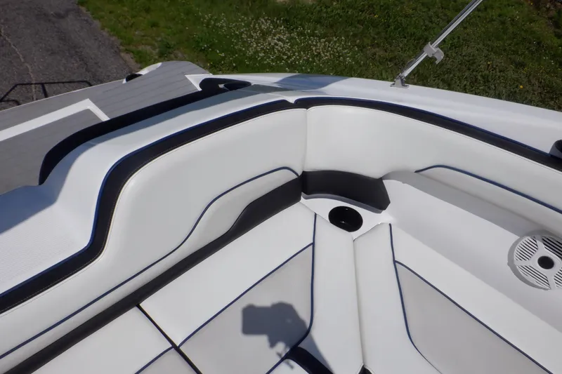 Slide: The Image of 2019 Yamaha Boats SX210 interior seating with white upholstery and black accents. - 48