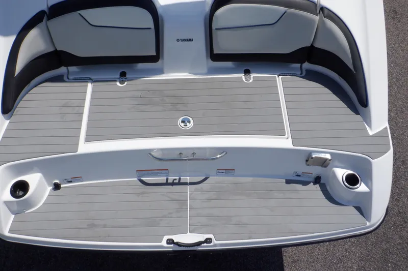 Slide: The Image of 2019 Yamaha SX210 boat deck with gray flooring and seating area. - 9