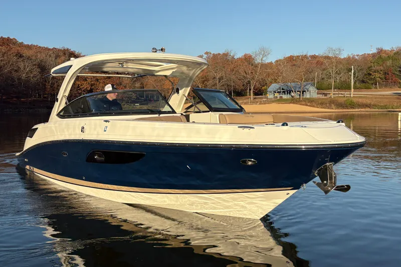 The Image of 2016 Sea Ray 350 SLX boat on calm lake with autumn trees in background. - 0
