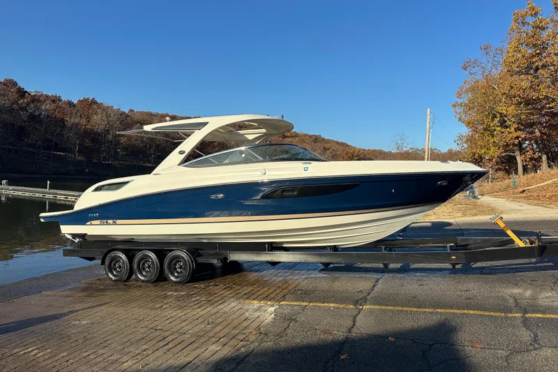 Slide: The Image of Luxurious 2016 Sea Ray 350 SLX boat interior with tan seating and wooden flooring. - 11