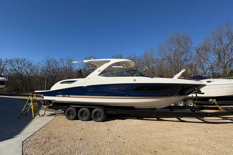 Slide: The Image of 2016 Sea Ray 350 SLX cockpit with leather seats and wooden flooring. - 12