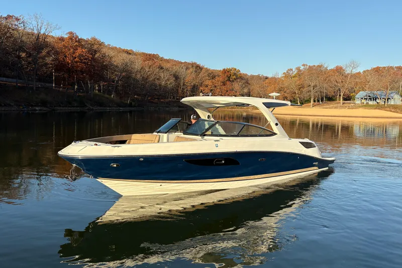 Slide: The Image of 2016 Sea Ray 350 SLX boat on trailer under clear blue sky. - 2