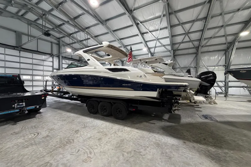 Slide: The Image of 2016 Sea Ray 350 SLX boat storage compartment with beige seating and mechanical components. - 36