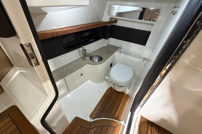 Slide: The Image of 2016 Sea Ray 350 SLX boat interior with kitchenette, seating, and blue LED lighting. - 44
