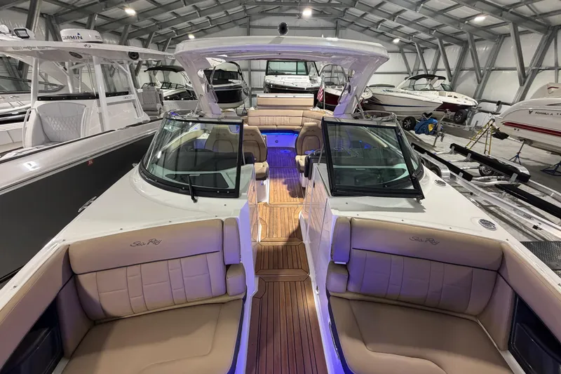Slide: The Image of 2016 Sea Ray 350 SLX luxury boat interior with tan seating and blue lighting. - 49